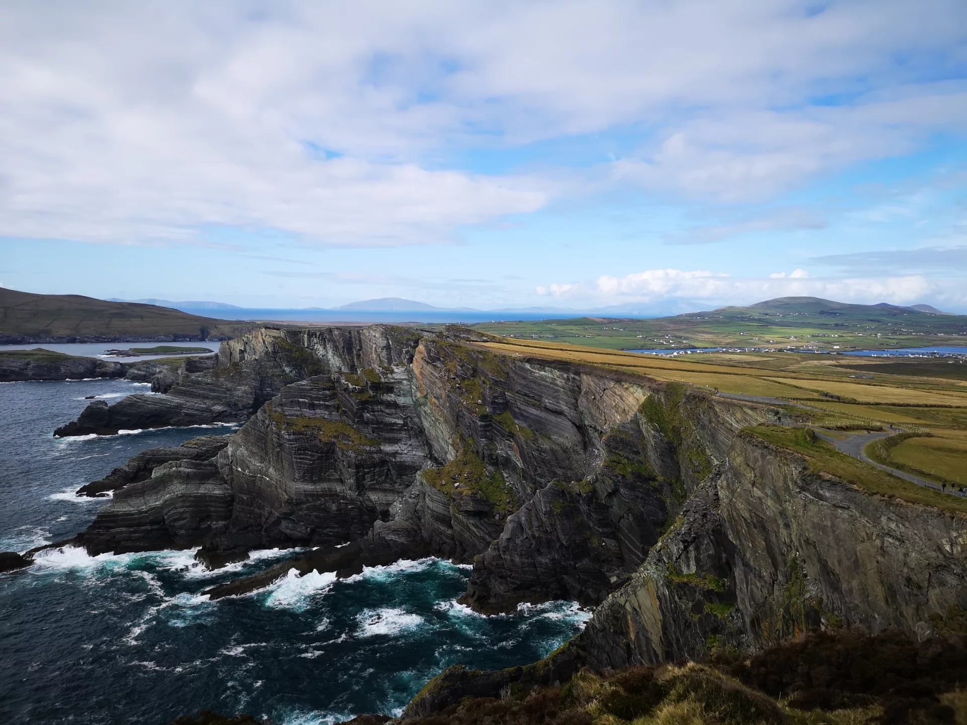 Irland-Roadtrip: Kontrast der Kerry Cliffs am Atlantik zur sanften, grünen Hügellandschaft Irlands